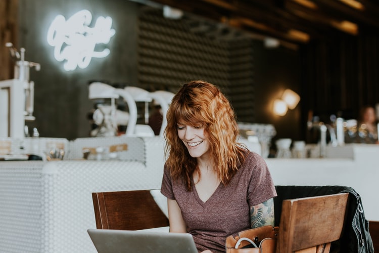 woman smiling at computer