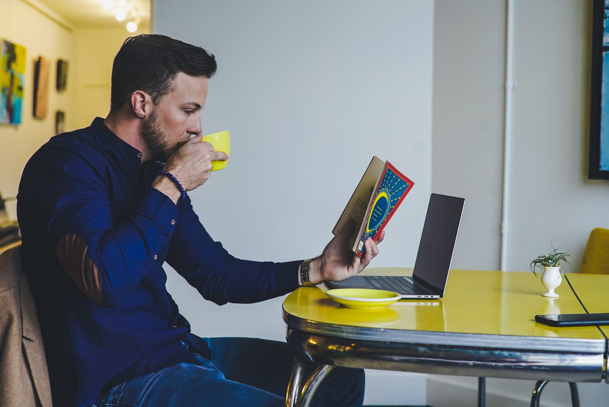 man reading and drinking coffee at the same time