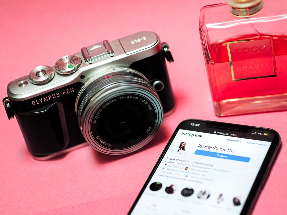 instagram on phone, perfume and camera