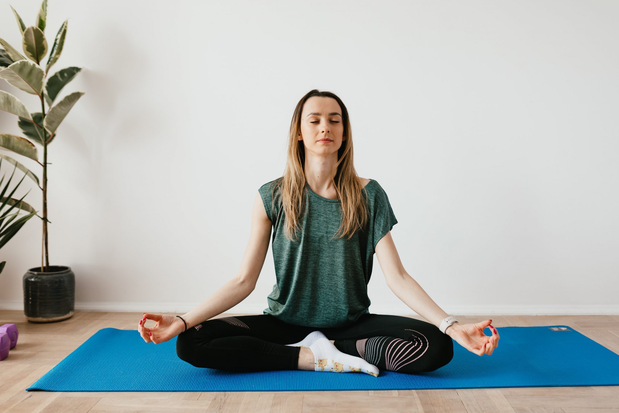 woman meditating on yoga mat