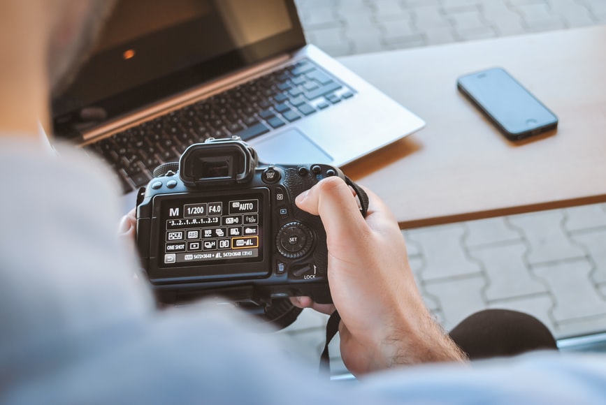 person holding digital camera