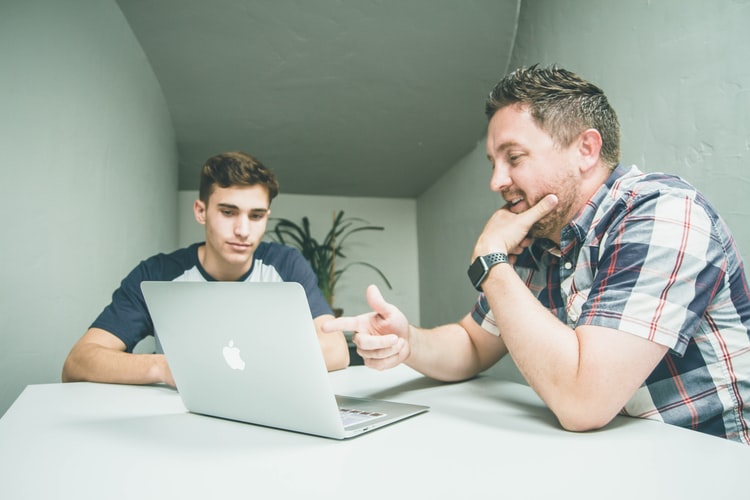 men working together on laptop