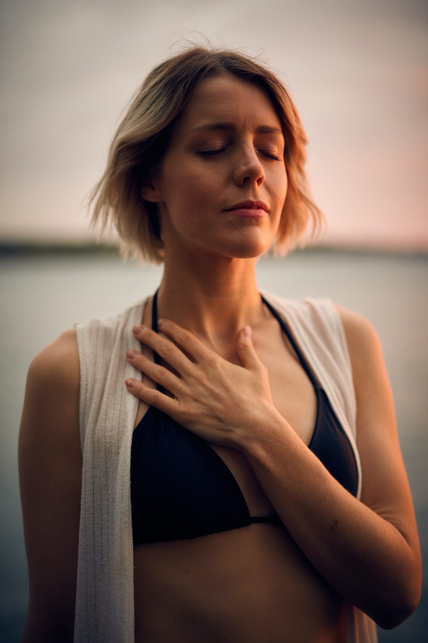 woman meditating with hand on her heart