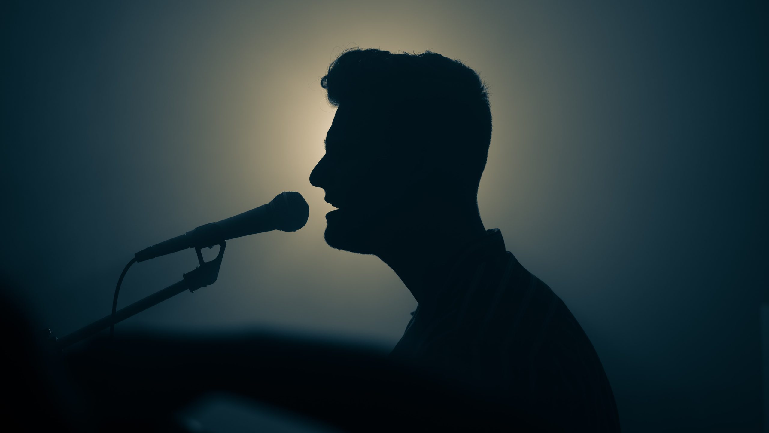 silhouette of man singing