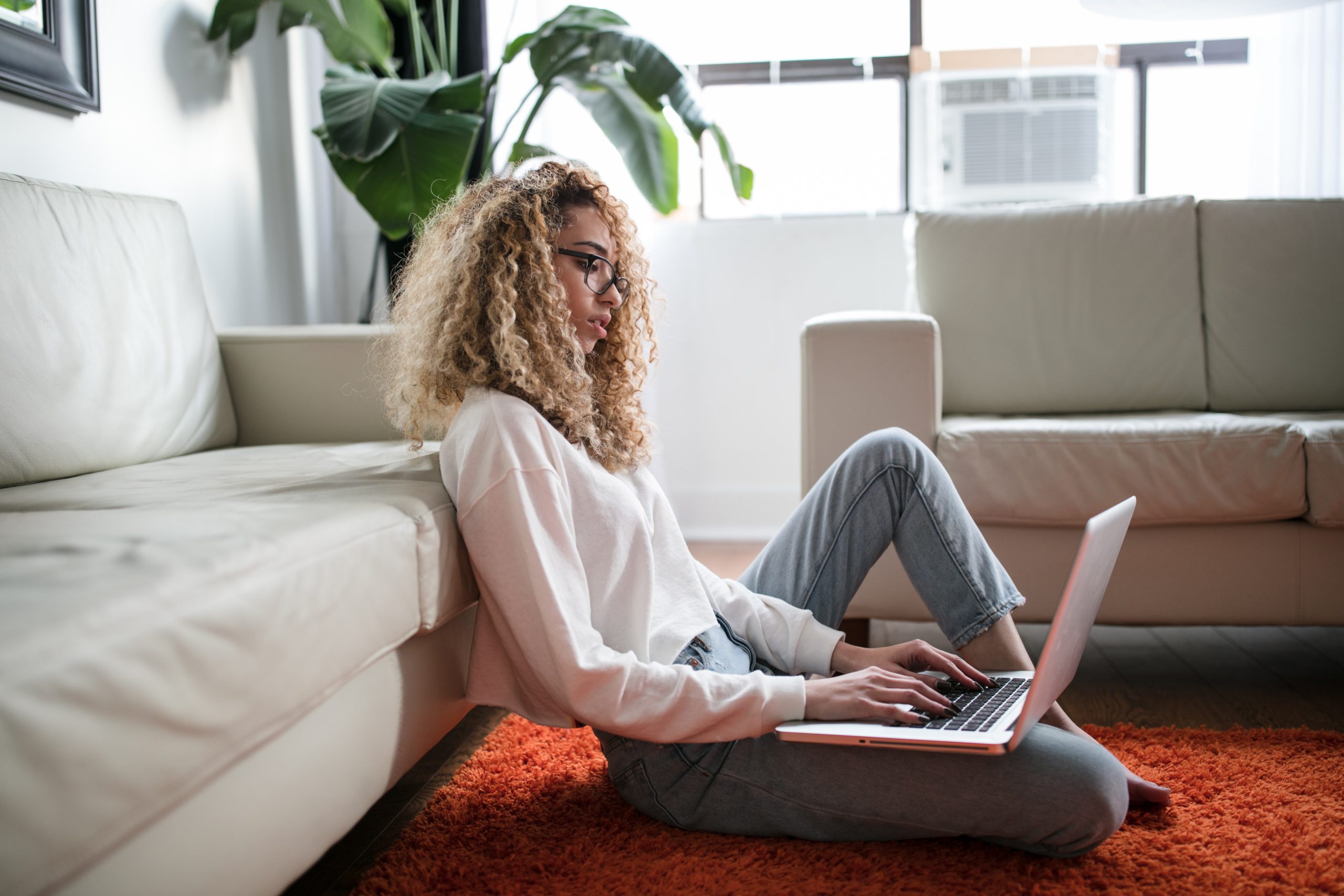 woman sitting while using laptop