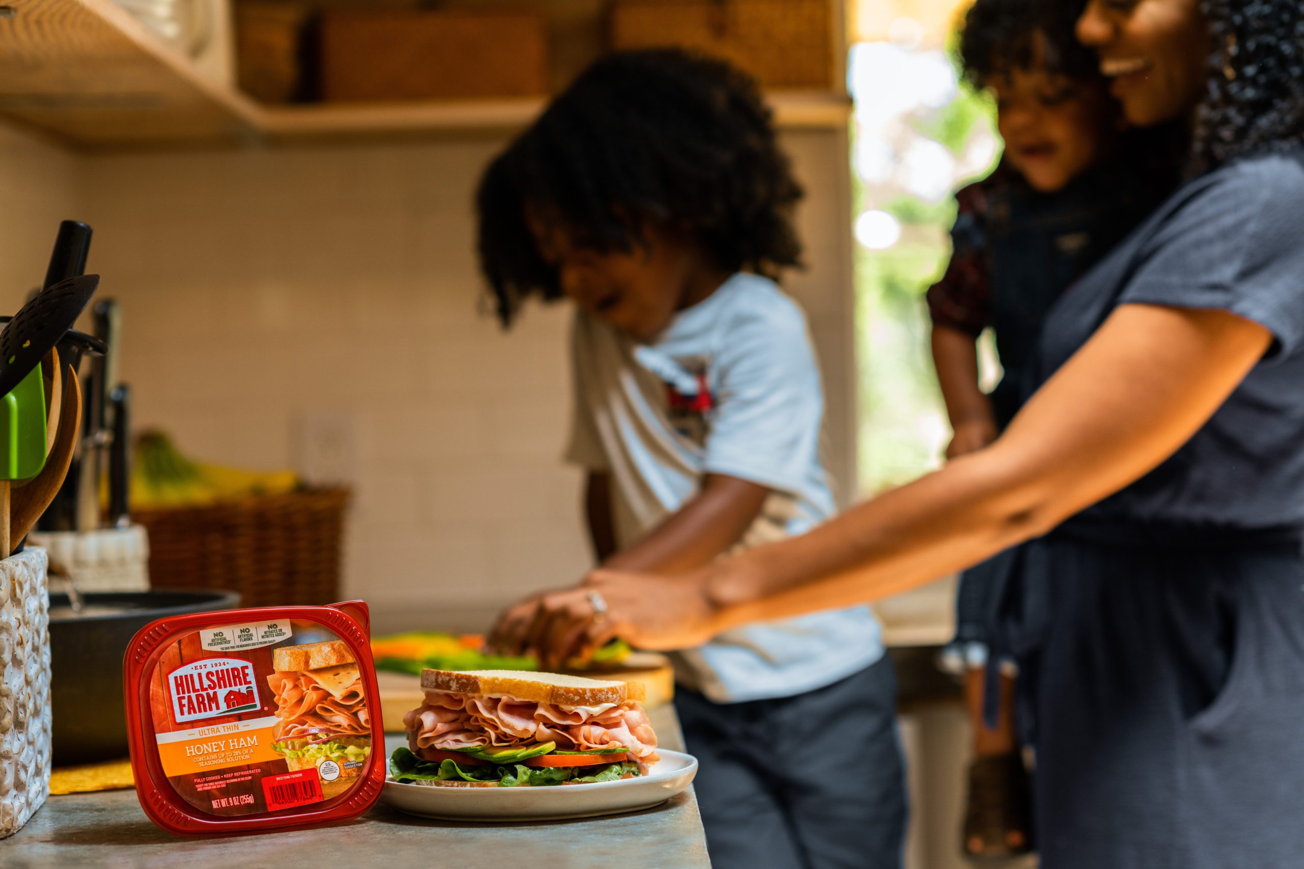 mom with kids making sandwiches