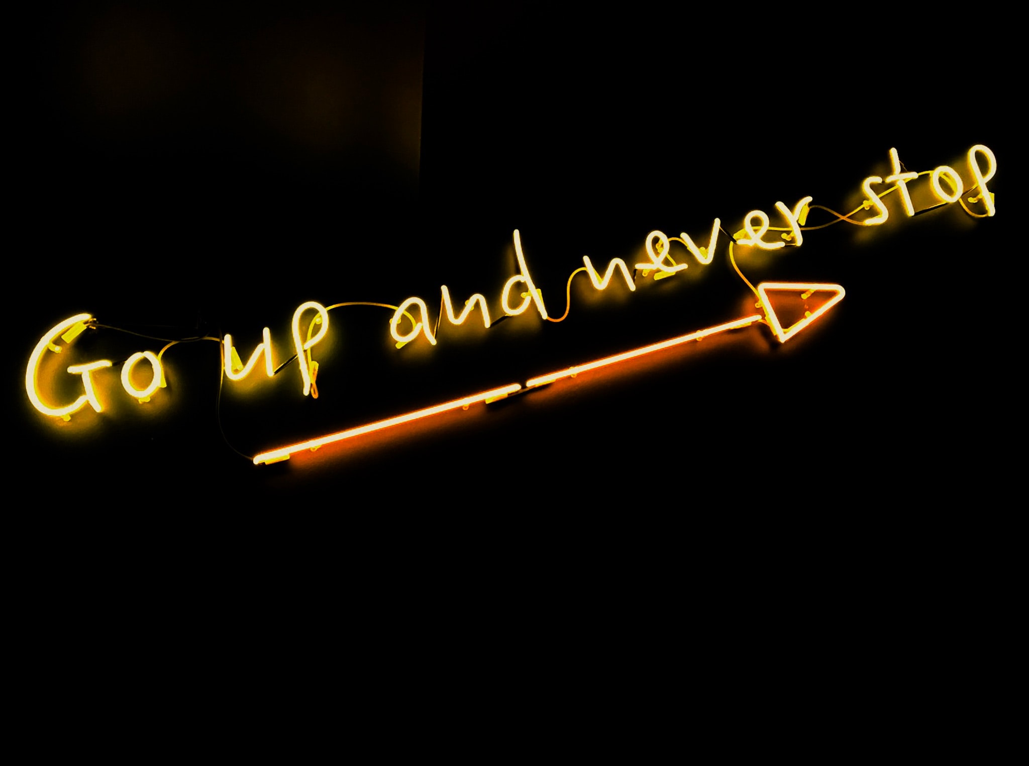 "Go up and never stop" on neon letters
