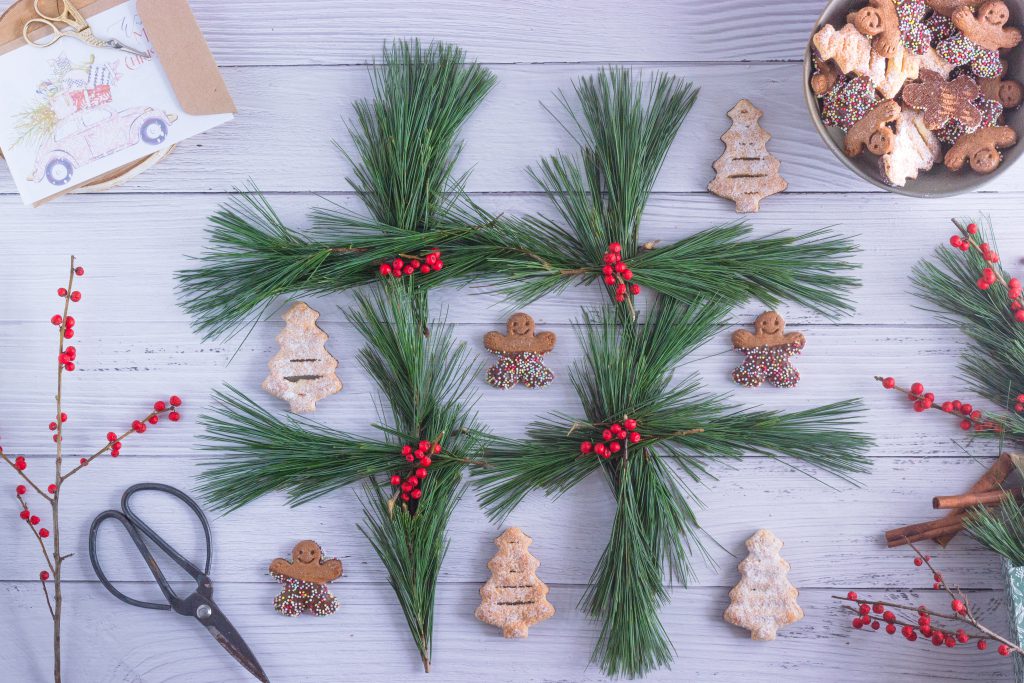 christmas tic-tac-toe made out of pine needles and cookies